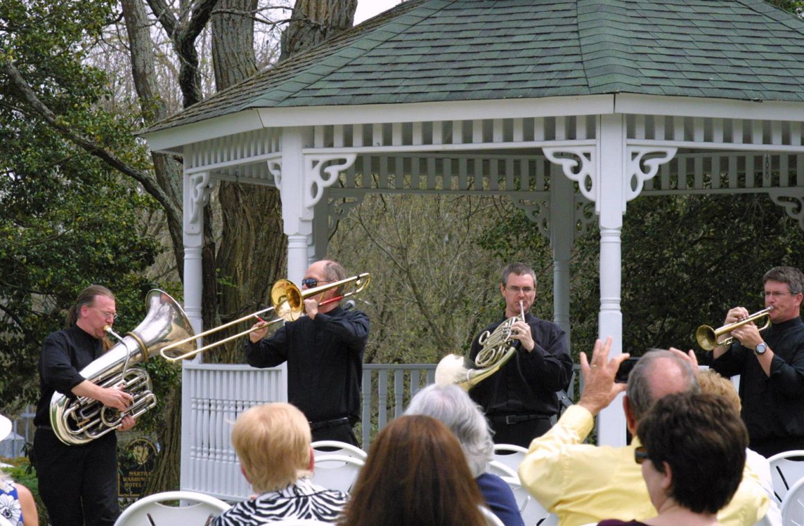 Members of Brass 5 playing for an outdoor festival.