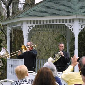 Members of Brass 5 playing for an outdoor festival.