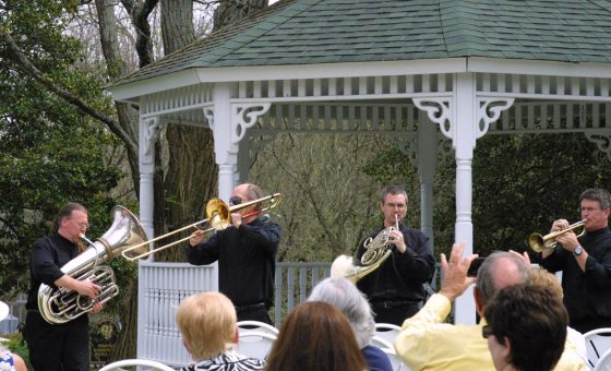 Members of Brass 5 playing for an outdoor festival.